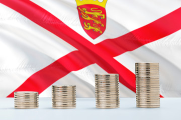 Fototapeta premium Jersey flag waving in the background with rows of coins for finance and business concept. Saving money.