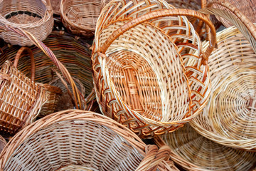 Fototapeta na wymiar Wicker straw basket close-up. Handmade wicker baskets are sold in the market.