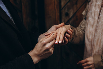 Young man makes a proposal to get married and put ring on finger. She said yes