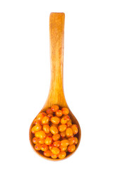 heap of sea buckthorn in wooden spoon isolated on white