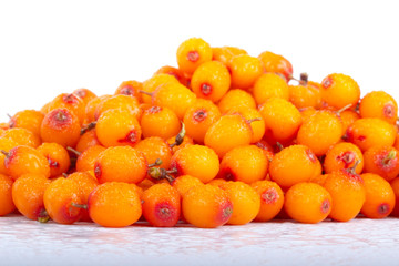 heap of sea buckthorn with water drops  isolated on white