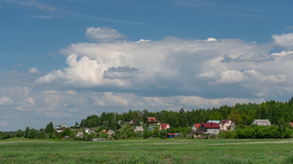 Fototapeta na wymiar landscape with houses and blue sky and clouds