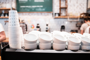 Stack of small ceramic cups on shelf.