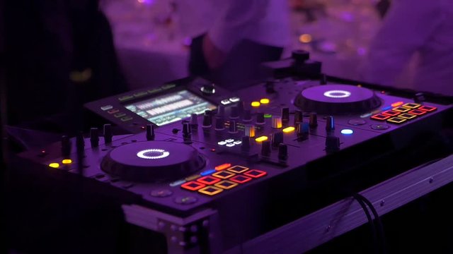 Dj playing music in night club 