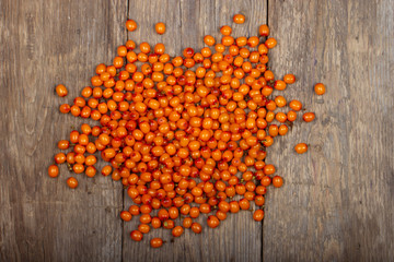 heap of sea buckthorn on wooden background