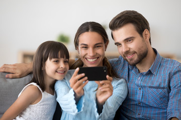 Happy family with child smile making selfie on cell
