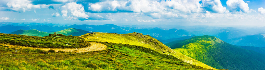 Plakat Carpathians in summer day. Mountains against the sunny blue sky with clouds on background