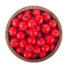 heap of red ashberries in wooden cup isolated. top view
