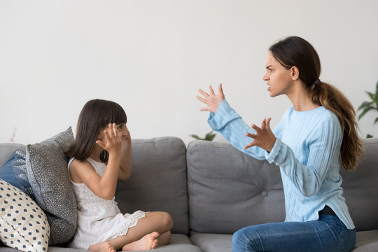 Angry young mom gesture arguing with little kid