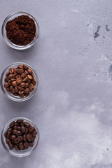 Top view of  different varieties of coffee beans on dark  background.