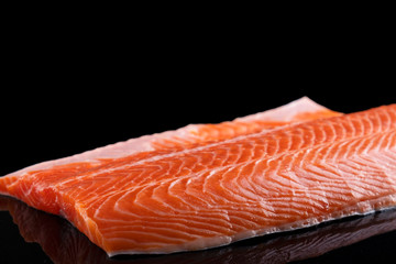 Raw salmon filet  isolated on dark  background.