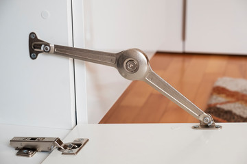 Metal hinges in a cupboard.  Furniture