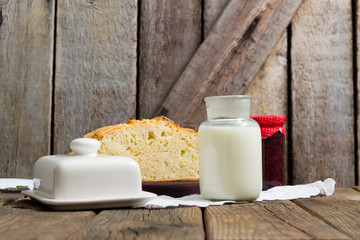 breakfast jam milk half bread on old wooden