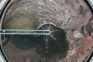 Aerial view of round storage tank in water treatment and cleaning plant