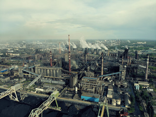 Obraz premium Aerial view of Industrial zone, plants and factories with smoke from chimneys. Air pollution