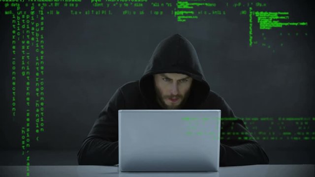 Male hacker using a laptop