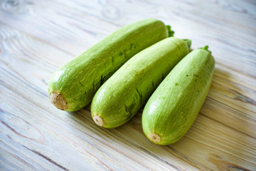 Fresh zucchini on wooden background. Top view.