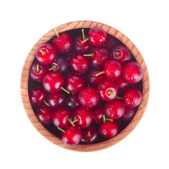 red chokecherry in wooden cup isolated on white background. top view