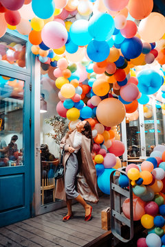 Woman on the background of wooden door with balloons