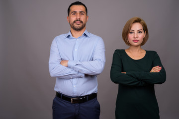 Multi-ethnic couple in love against gray background