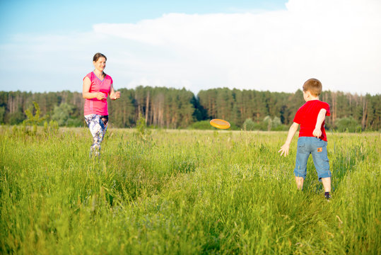 Mom and son play frisbee, Chernigov, Ukraine, May 30, 2019.