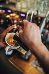 Barista making coffee in coffee shop, cappuccino and latte art. 