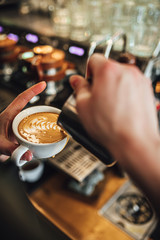 Barista making coffee in coffee shop, cappuccino and latte art. 