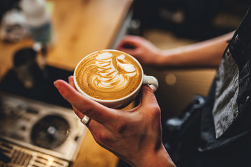 Barista making coffee in coffee shop, cappuccino and latte art. 