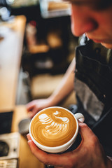 Barista making coffee in coffee shop, cappuccino and latte art. 