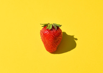 Fresh Strawberry close up. Strawberry isolated on bright yellow background. Free space