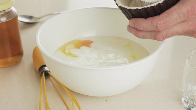 Making dough for pancakes - add a tablespoon of sugar to a white plastic bowl - homemade traditional sweet breakfast step by step - recipe for a simple and nutritious dish