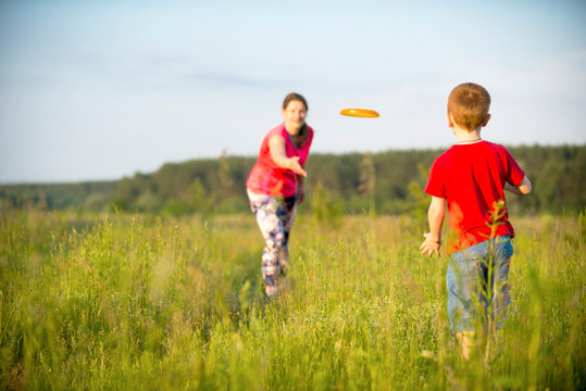 Mom and son play frisbee, Chernigov, Ukraine, May 30, 2019.