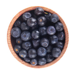 heap of bilberries in wooden cup isolated on white background. top view