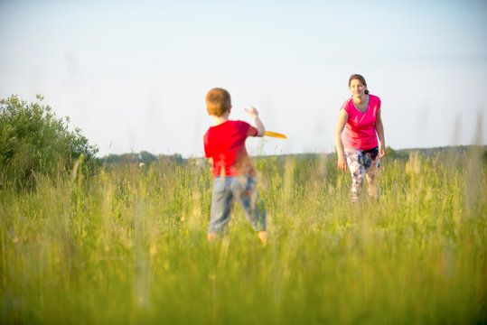 Mom and son play frisbee, Chernigov, Ukraine, May 30, 2019.