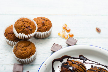 chocolate cupcakes, old white wooden table