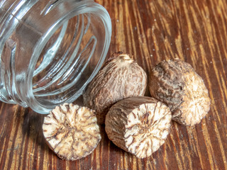 Fototapeta na wymiar nutmeg spice isolated on the wooden background