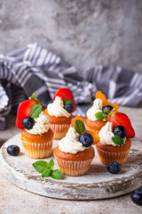 Cupcakes with cream and berries