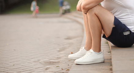 young man talking on a mobile phone, sitting on the steps in the