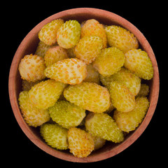 heap of  yellow wild strawberry in wooden cup isolated on black. top view