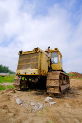Obraz premium Yellow, old, rusty bulldozer on track.