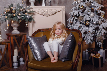 Little cute and funny girl near christmas tree