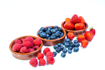 Frische Beeren in Schalen auf weißem Hintergrund