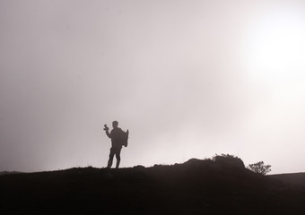silhouette of man on top of mountain