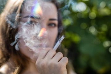 Obraz premium girl playing around and smoke a cigarettes in the city berlin by tigerraw