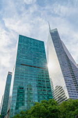 Obraz na płótnie Canvas New York City Skyscrapers, Bright Sun, and Beautiful Cloudy Blue Sky