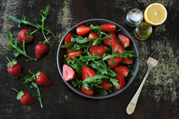 Fresh juicy salad with strawberries and arugula. Vegan diet Healthy food. Fitness salad.