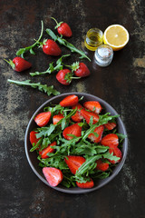 Fresh juicy salad with strawberries and arugula. Vegan diet Healthy food. Fitness salad.