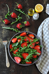 Fresh juicy salad with strawberries and arugula. Vegan diet Healthy food. Fitness salad.