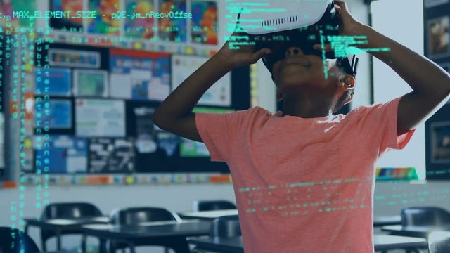 Boy using virtual goggles inside a classroom
