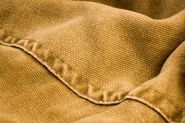 clothing items stonewashed cotton fabric texture with seams, clasps, buttons and rivets, macro